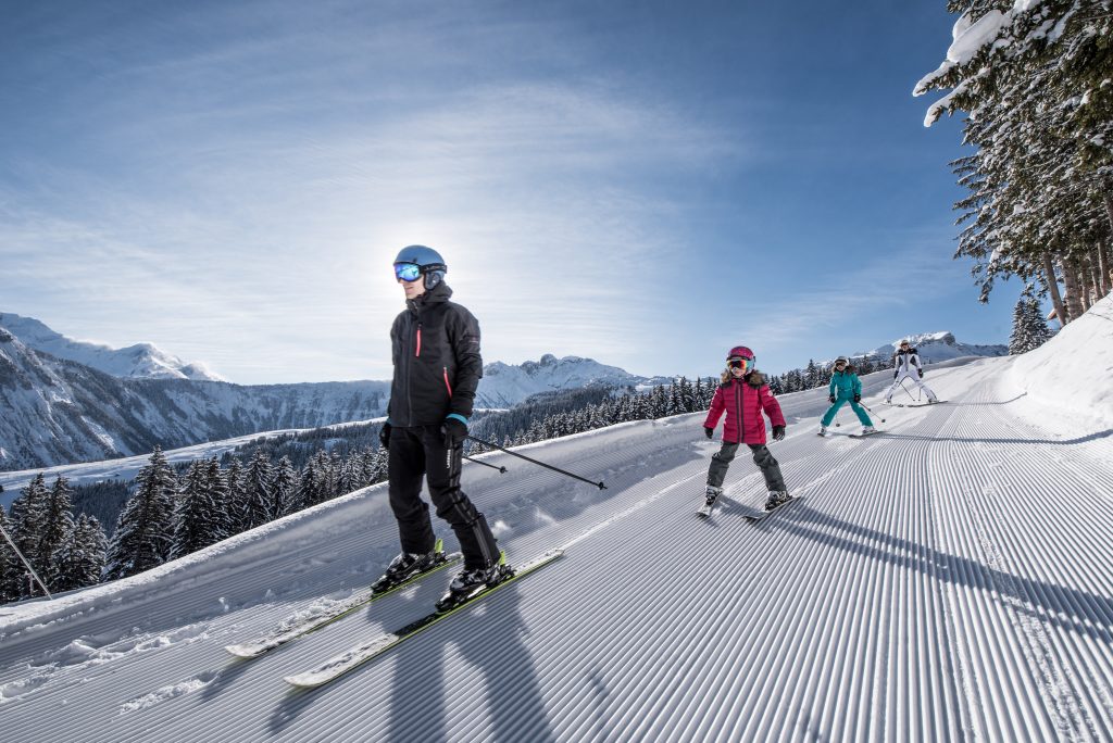 A family skiing on cheap ski hire in Courchevel